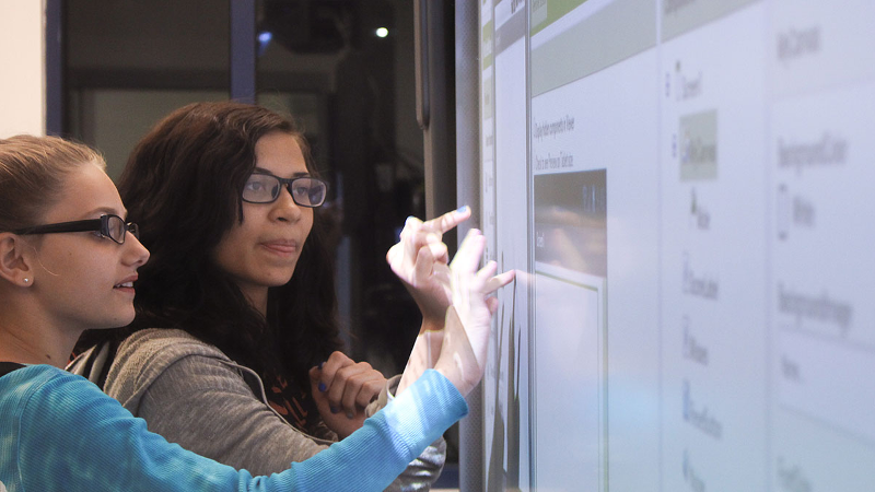 Two girls at a Smartboard