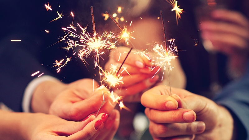 People holding sparklers in celebration